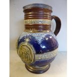 A Doulton Lambeth stoneware jug of bulbous form with a wide, straight neck,