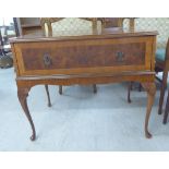 A modern crossbanded burr walnut finished stereo cabinet, the hinged lid over a facsimile drawer,