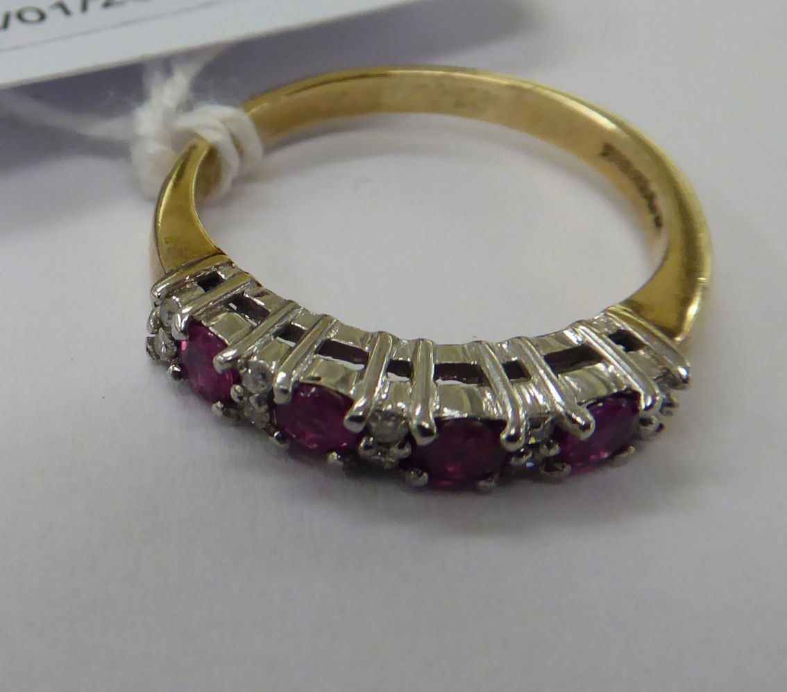 A 9ct gold claw set ruby and diamond half eternity ring 11