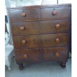 A late Victorian mahogany five drawer dressing chest, raised on turned,