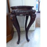 A mid 20thC Asian fruitwood jardiniere,