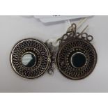 A pair of silver disc shaped and filigreeworked drop earrings,