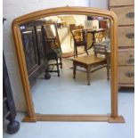 A Victorian style overmantel mirror, set in an arched,