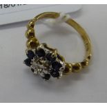 A 9ct gold claw set sapphire and diamond cluster ring 11