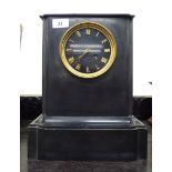 A late Victorian black slate cased mantel clock with a platform top, over straight sides,