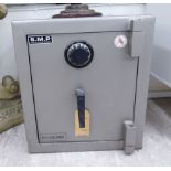 An SMP safe with a combination lock 20''h 19''w F