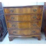 A Georgian style mahogany serpentine front, four drawer dressing chest,