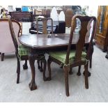 A 1920s oak wind-out dining table, raised on cabriole legs,