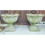 A pair of composition stone pedestal garden planters,