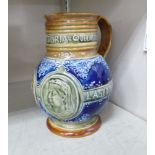 A Doulton Lambeth stoneware water jug of spherical form with a wide neck and loop handle,