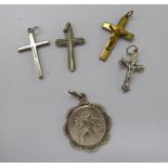 Three silver pendant crosses; another; and a silver St.