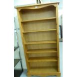 A modern stained pine five tier open front bookcase,