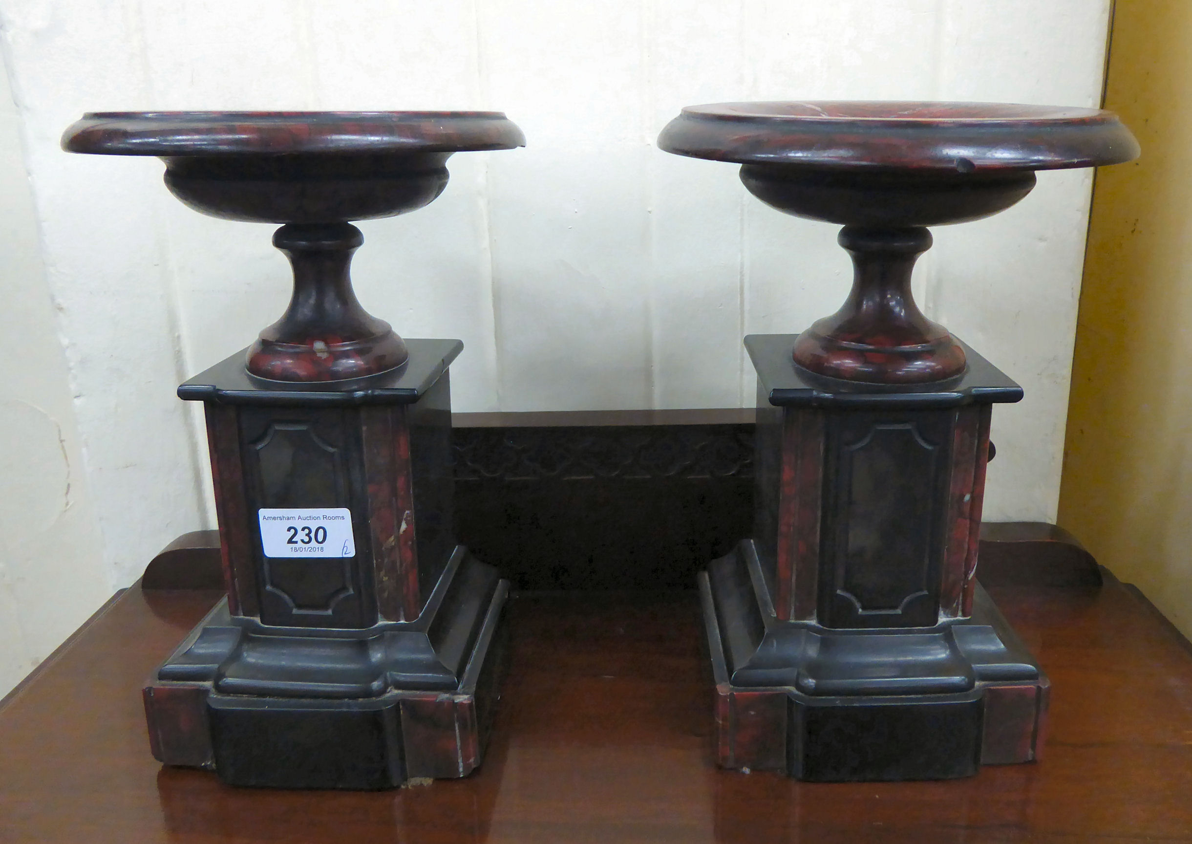 A pair of late Victorian black slate and mottled red marble side pieces, each with a dished top,