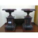 A pair of late Victorian black slate and mottled red marble side pieces, each with a dished top,