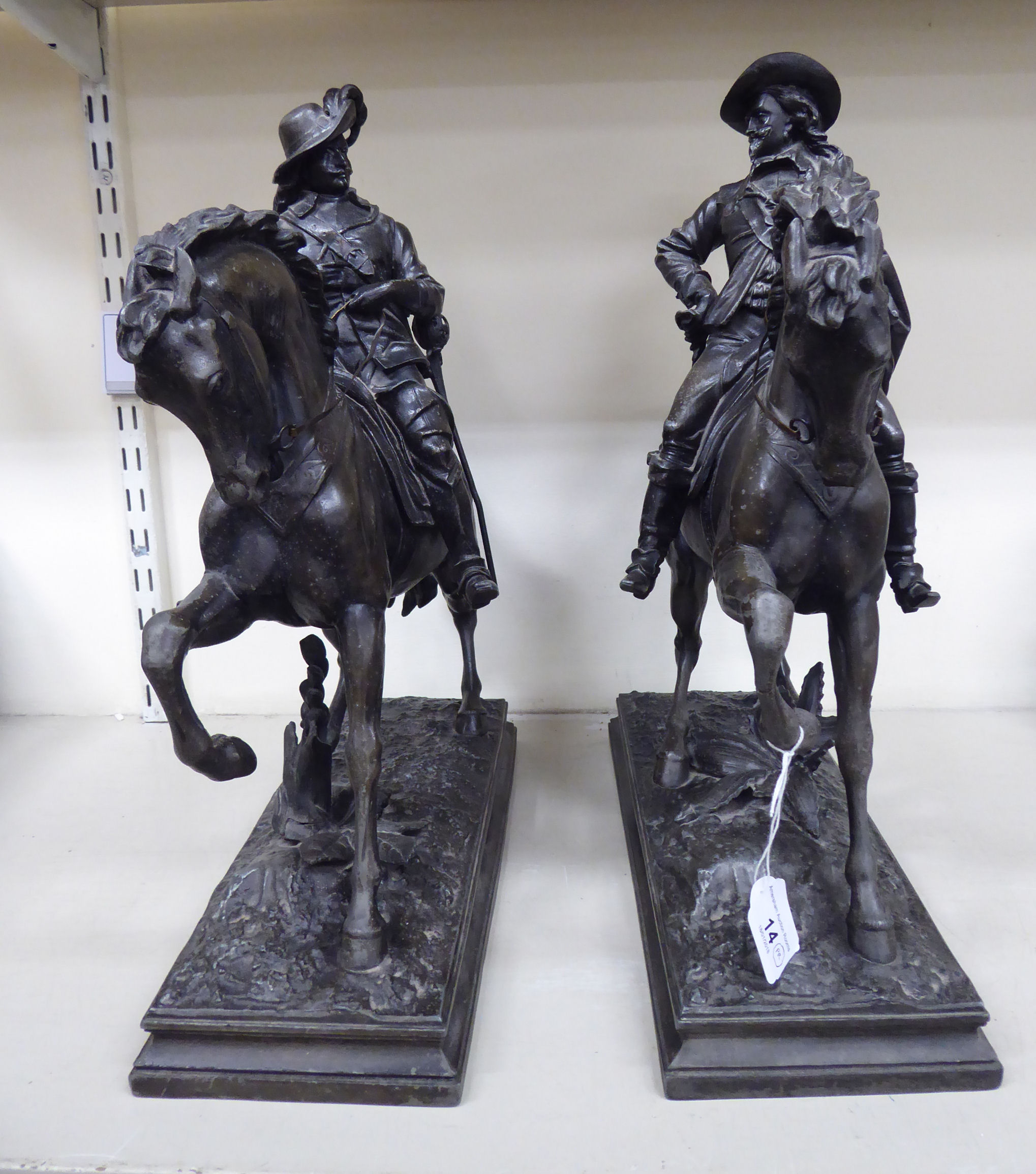 A pair of late 19th/early 20thC cast spelter figures, Cavaliers on horseback,