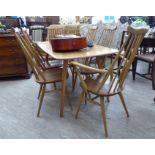 An Ercol light elm and beech dining table, raised on square, tapered,