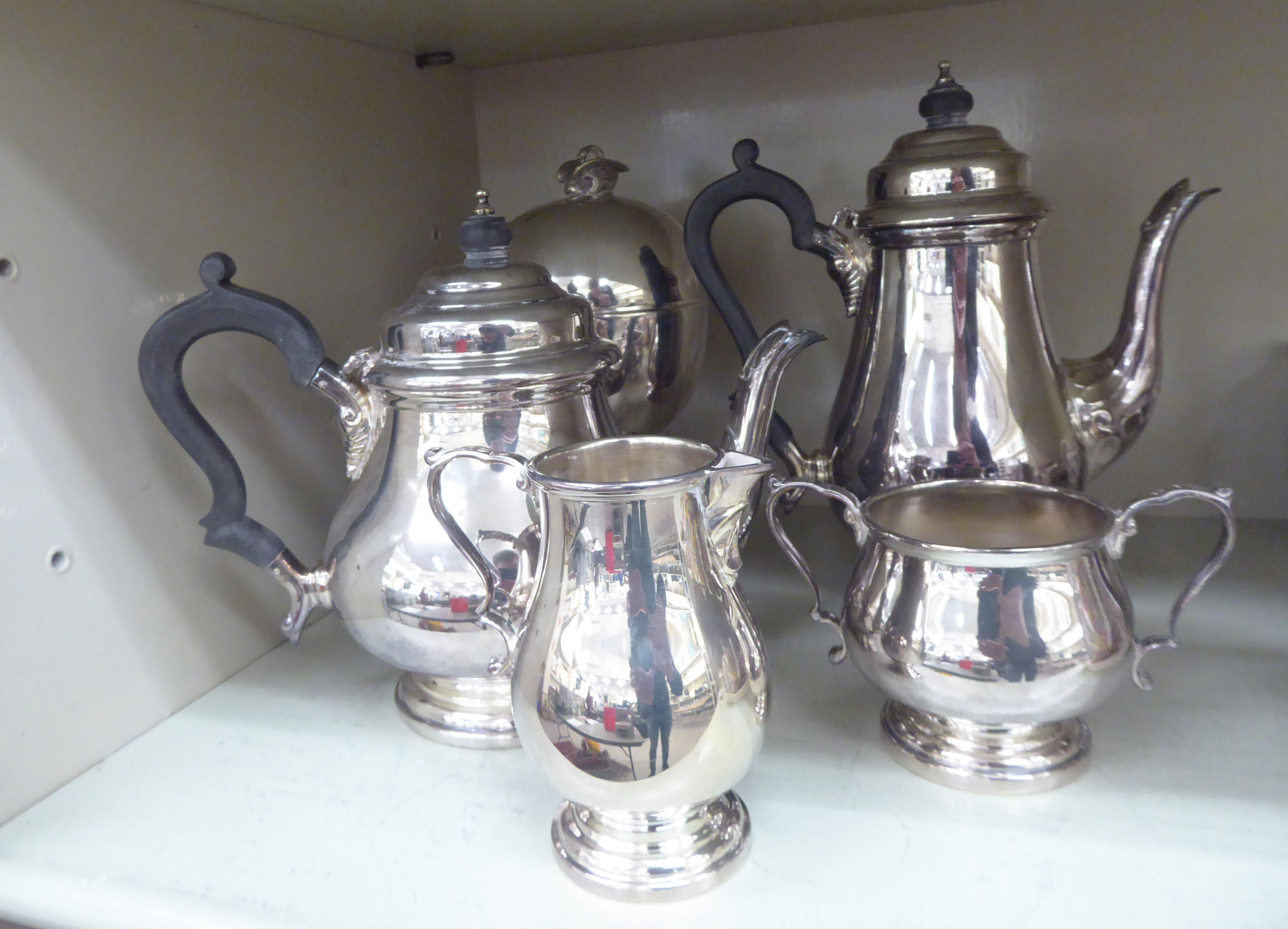 An Asprey silver plated four piece tea set comprising a teapot, coffee pot,