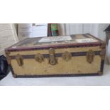 An early 20thC canvas covered cabin trunk with a hinged lid and straight sides 13''h 36''w