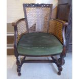An early 20thC stained beech framed salon chair with a pierced, C-scrolled and foliate carved crest,
