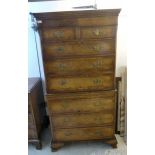 A Georgian style mahogany and walnut finished chest-on-chest with a dentil moulded cornice,