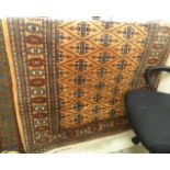 A Turkoman rug with repeated diamond motifs,