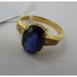 A gold coloured metal claw set sapphire and diamond ring 11