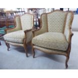 A pair of modern bamboo effect softwood framed salon chairs, the patterned fabric backs,