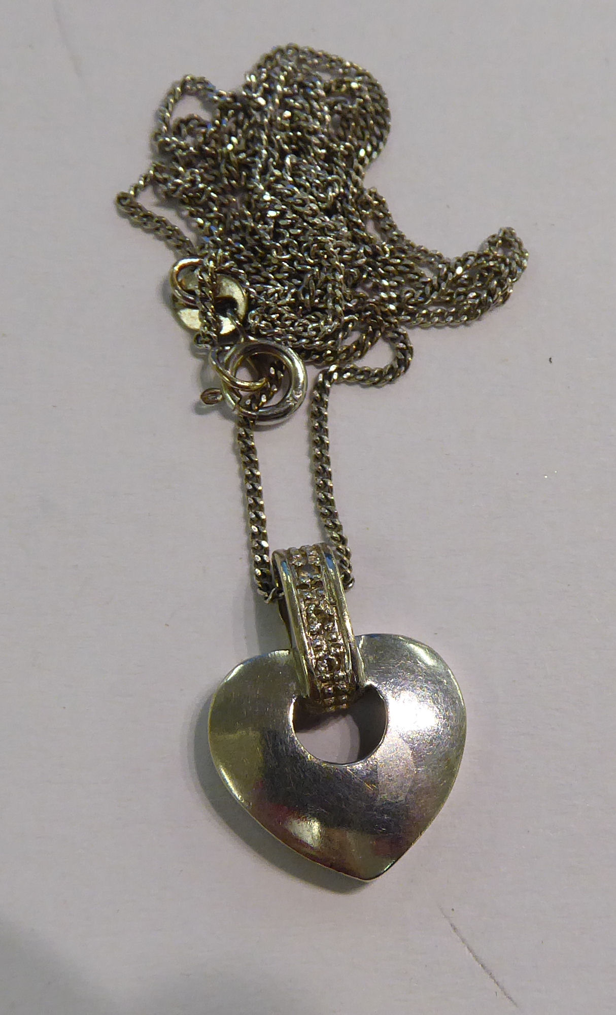 A 9ct white gold heart shaped pendant,