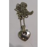 A 9ct white gold heart shaped pendant,