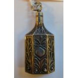 A silver coloured metal filigreeworked perfume bottle,