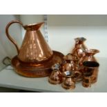 19thC and later metalware: to include a graduated set of six copper jugs with loop handles