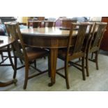 An early 20thC mahogany wind-out extending dining table, the top with round corners,