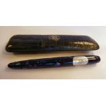 A Frank Muller ballpoint pen, in a marbleised blue case with a two part,