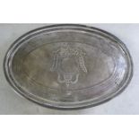 A George III silver oval teapot stand with a raised border,