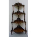 A late Victorian string inlaid walnut and marquetry four tier serpentine front waterfall corner