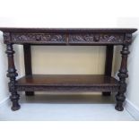 A late Victorian stained and profusely carved oak buffet,