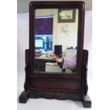 A late 19thC Chinese padouk wood framed table screen, set with a mirror plate,