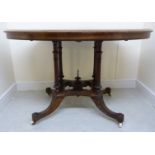 A mid 19thC figured walnut and ebonised centre table, the oval top elevated on four outset,