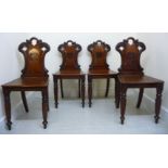 A set of four late Georgian mahogany framed hall chairs,