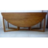 A 1960s Carl Hansen design teak dining table with D-shaped fall flaps,