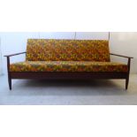 A 1960s Finland teak framed bed settee with level arms, raised on eliptically turned legs,