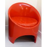 A 1960s/70s Evans of High Wycombe pillarbox red vinyl upholstered round tub chair with an integral