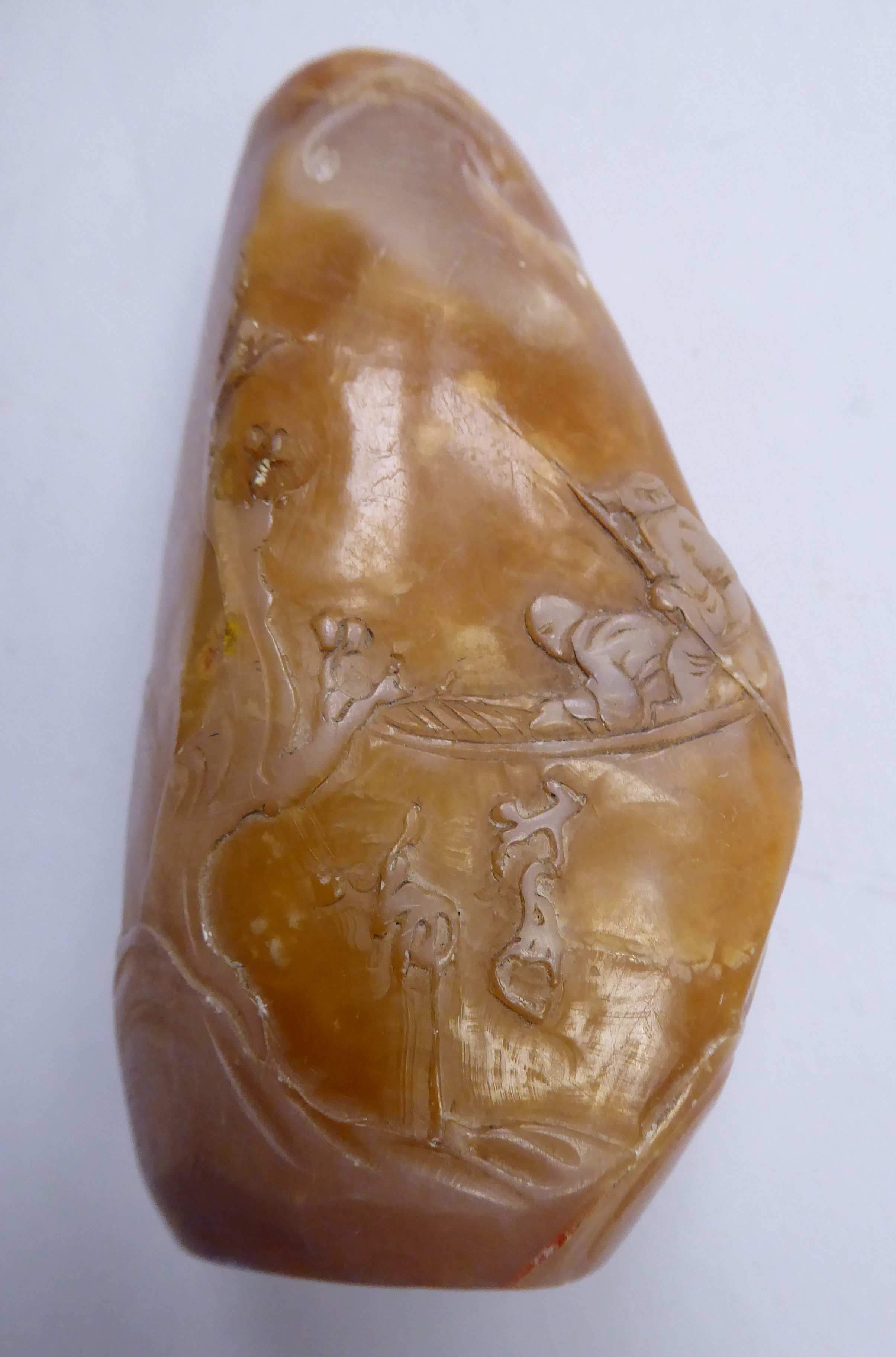 A late 19thC Chinese carved mottled brown soapstone seal of irregular form,