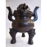 A 20thC Japanese cast and patinated bronze censer, the circular bowl with opposing, scrolled,