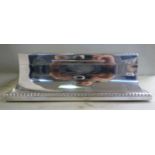 A silver cigar box of casket form with swept sides,