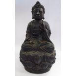A late 18th/early 19thC Asian cast and patinated iron figure, Buddha, seated crosslegged,