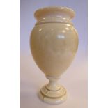 A mid 19thC turned ivory ovoid shaped vase, on a stepped pedestal foot 4.