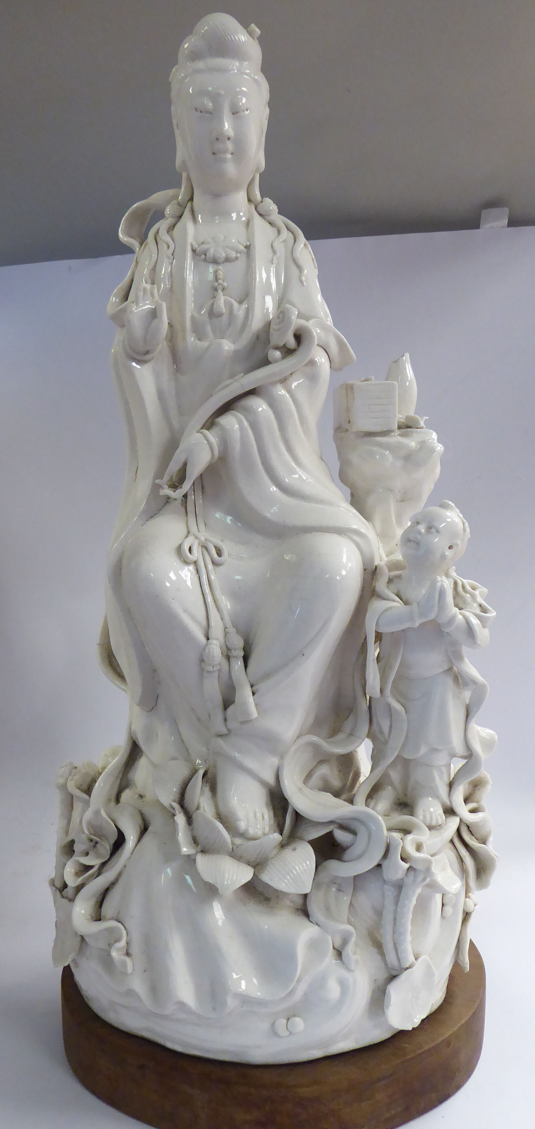 A late 18th/early 19thC Chinese blanc de chine porcelain figure Guan Yin seated,