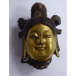 A Han Dynasty hollow cast bronze head with a parcel gilt smiling face,