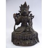 A 20thC Asian cast and patinated bronze, a religious figure, seated cross-legged,
